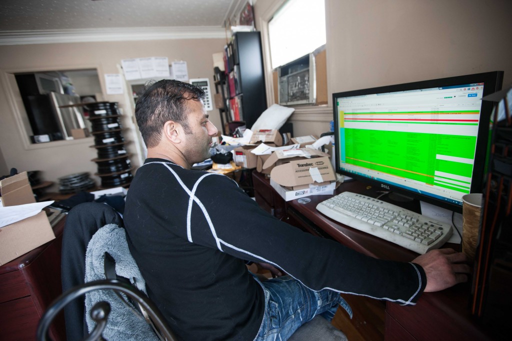 Shaheen Khan, manager of Ottawa Tires Direct, scrolls through his company’s enormous customer management spreadsheet, which keeps track of thousands of winter tire and rim purchases and orders.   PHOTO: Jesse Winter/ The Gridlock 