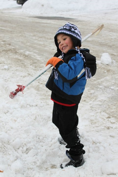 Grayson Trembleau showing off his signature slap shot with his older brothers’ hockey stick. 