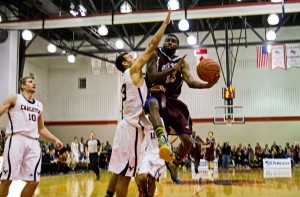 Gee-Gees forward Terry Thomas's jump-shot's past a Raven's centre (PHOTO: Philippe de Montigny)