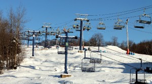 Skiers and snowboarders ride a chairlift up the mountain at Camp Fortune Friday afternoon (Roberta Bell, The Impact)