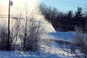A nozzle sprays mist into the air, which freezes and falls to make snow, on the mountain at Camp Fortune Friday (Roberta Bell, The Impact)