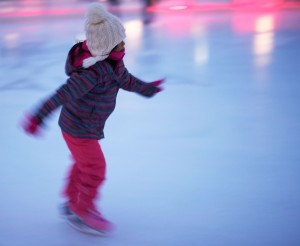 A bundled up little girl whizzes around the Rink of Dreams (Fangliang Xu, The Impact)