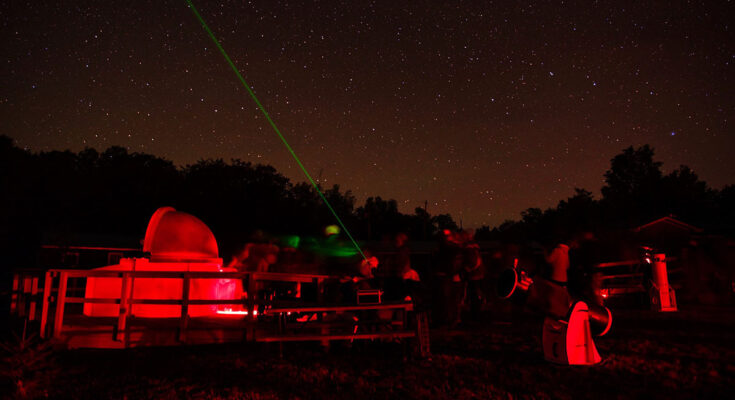 Observatory with telescopes and lasers looking at the night sky.