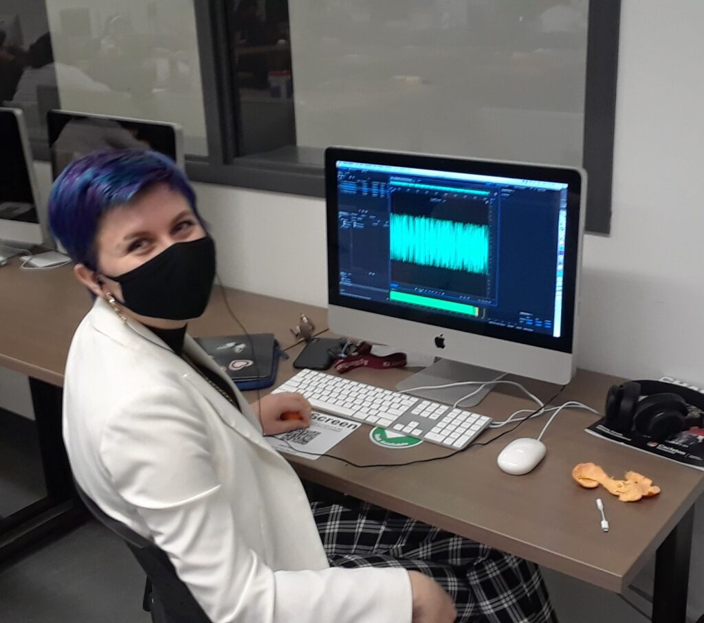 audio editor at computer looking relieved