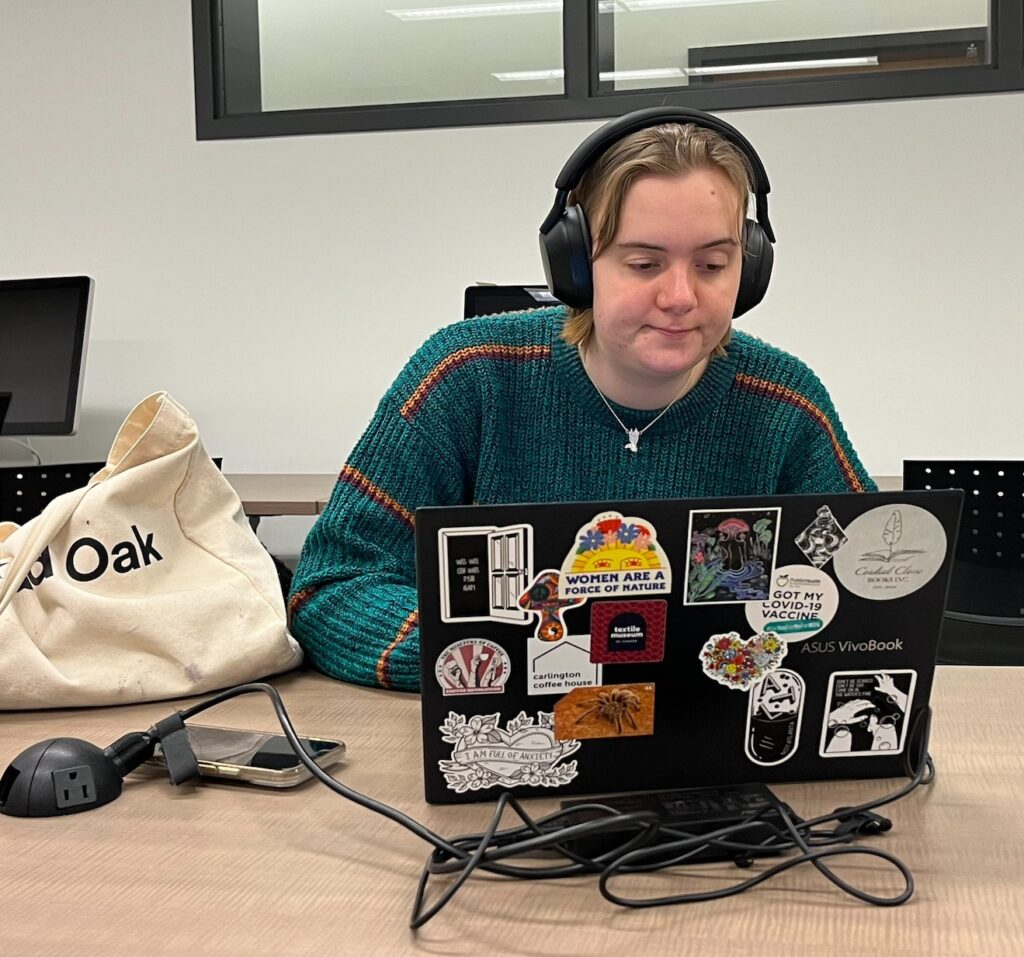 reporter in headphones working on computer