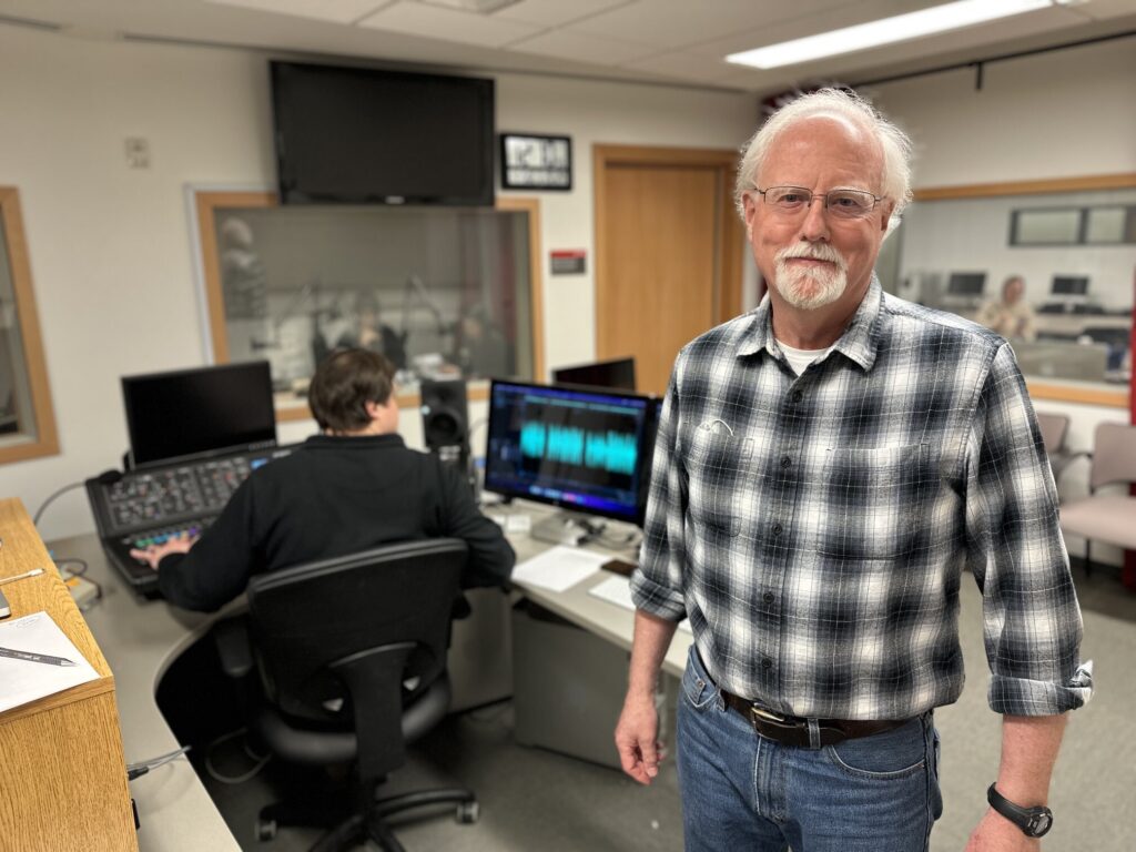 grizzled old gentleman smiling in radio student