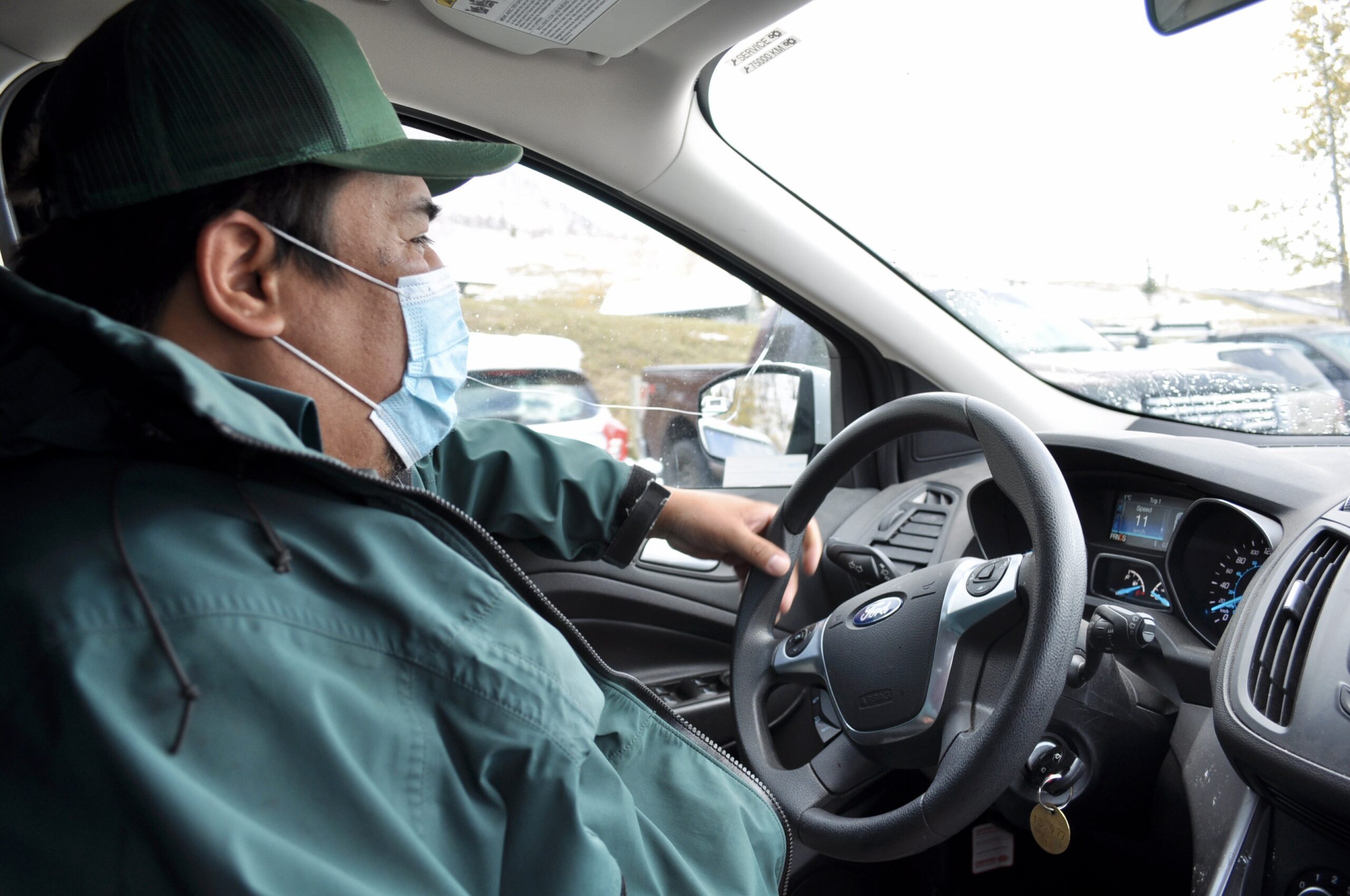 Kelly Tailfeathers rides around in his vehicle as part of his position as a resource management officer within Waterton Lakes National Park.