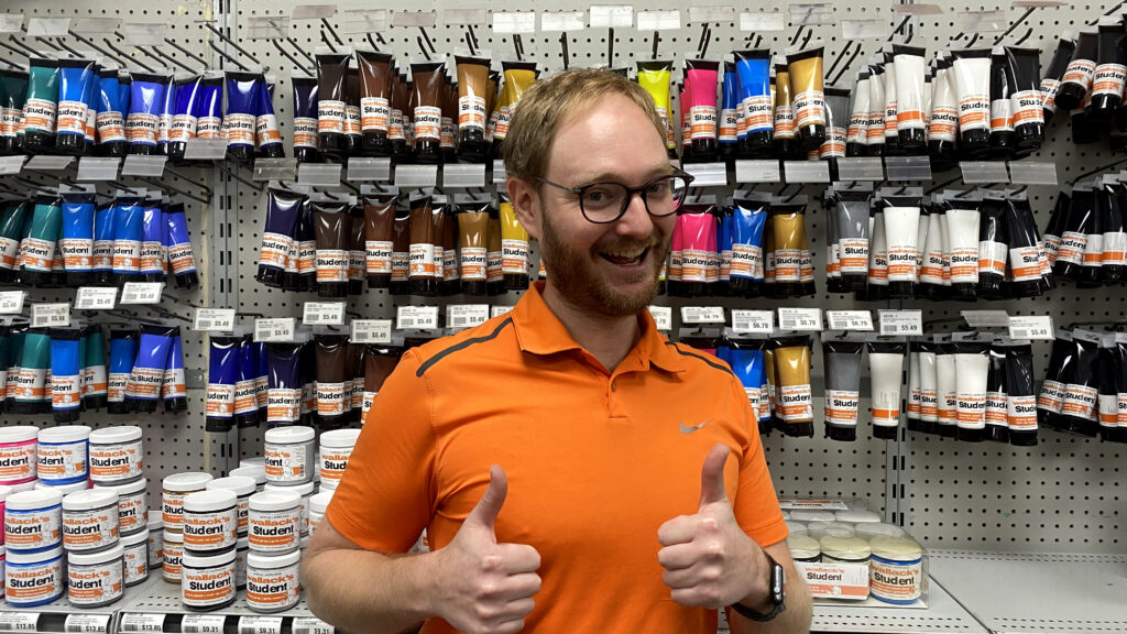 Michael Wallack gives two thumbs up inside Wallack's Art Supplies & Framing