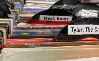 A cardboard record with a label saying Kanye West on it.