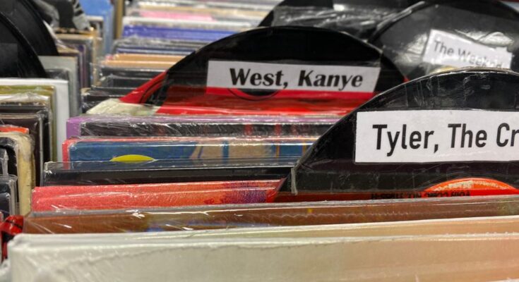 A cardboard record with a label saying Kanye West on it.