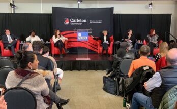 People on stage from left to right: Marco Mendicino, Erica Ifill, Rachel Gilmore, Joyce Napier, Sonia Verma, and Catherine Tait.