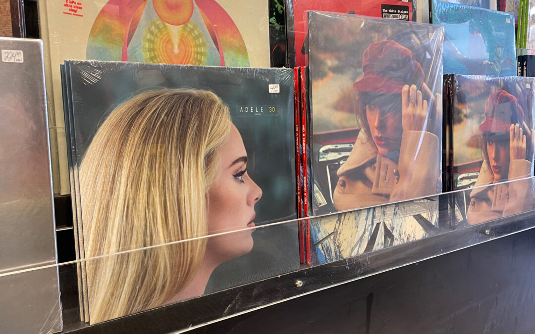 photos of album covers featuring Adele and Taylor Swift