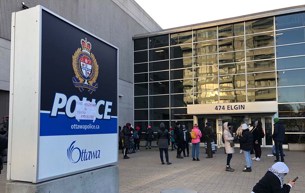 Residents gathered outside Ottawa Police Services headquarters on Tuesday evening to protest a proposed increase to the police budget.