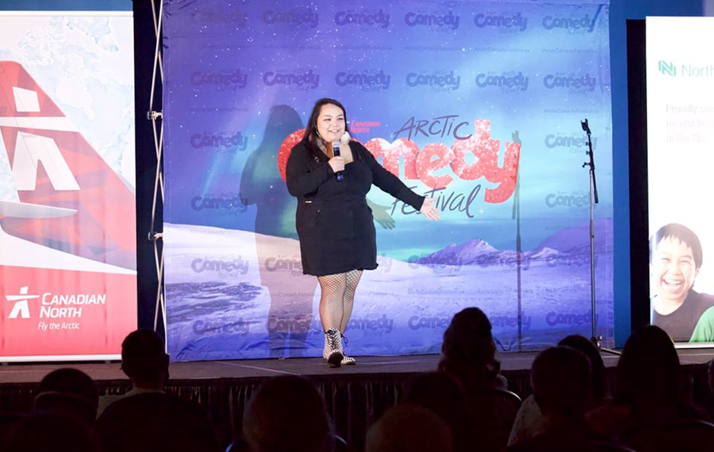 Nicole Etitiq performing on stage at Arctic Comedy Festival in October.