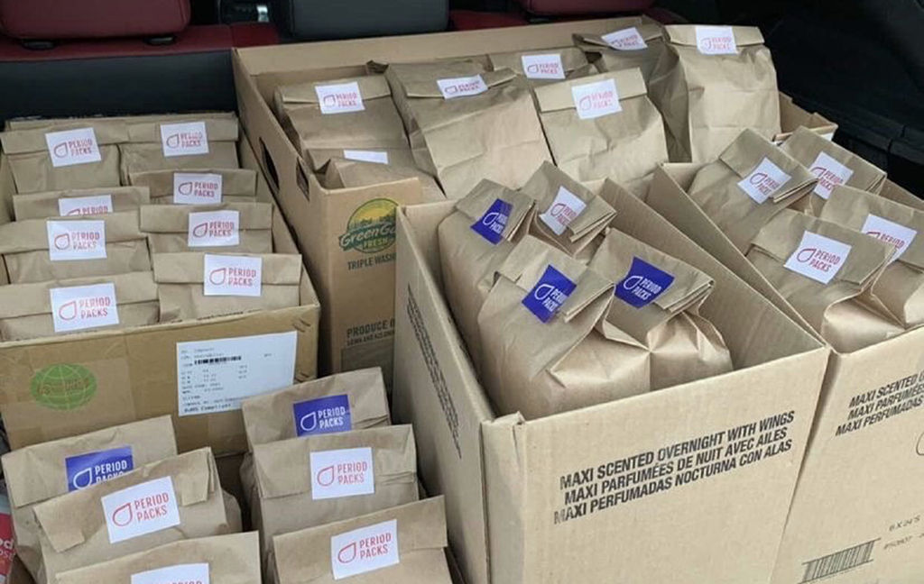 Boxes of period products in paper bags